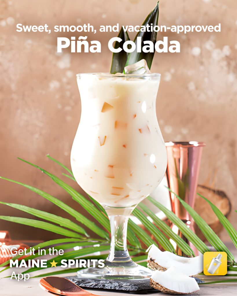 Pina Colada in a tall glass with pineapple and coconut decor.