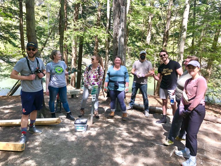 Group of people enjoying a team-building event in a forest.